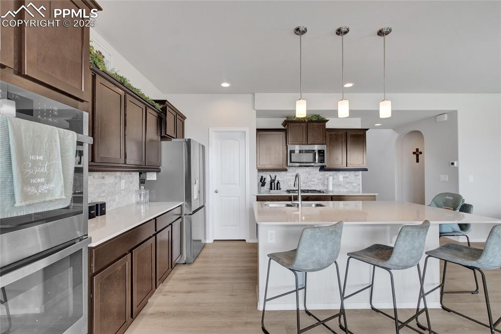 Image 10 of 41: Kitchen featuring appliances with stainless steel finishes, arched walkways