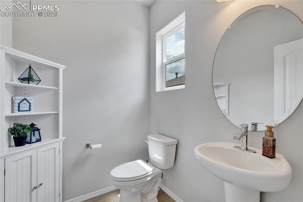 Image 18 of 41: Bathroom featuring toilet and wood finished floors