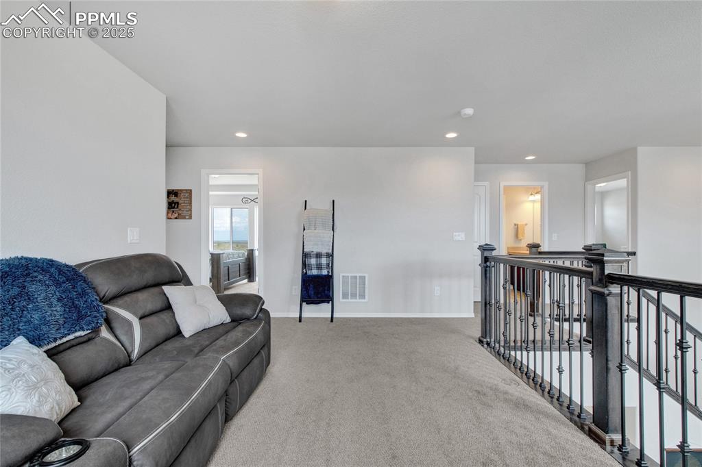 Image 20 of 41: Carpeted living room with recessed lighting