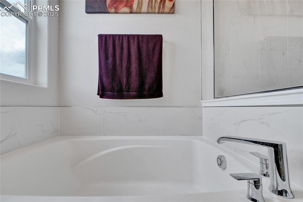 Image 26 of 41: Bathroom featuring a garden tub