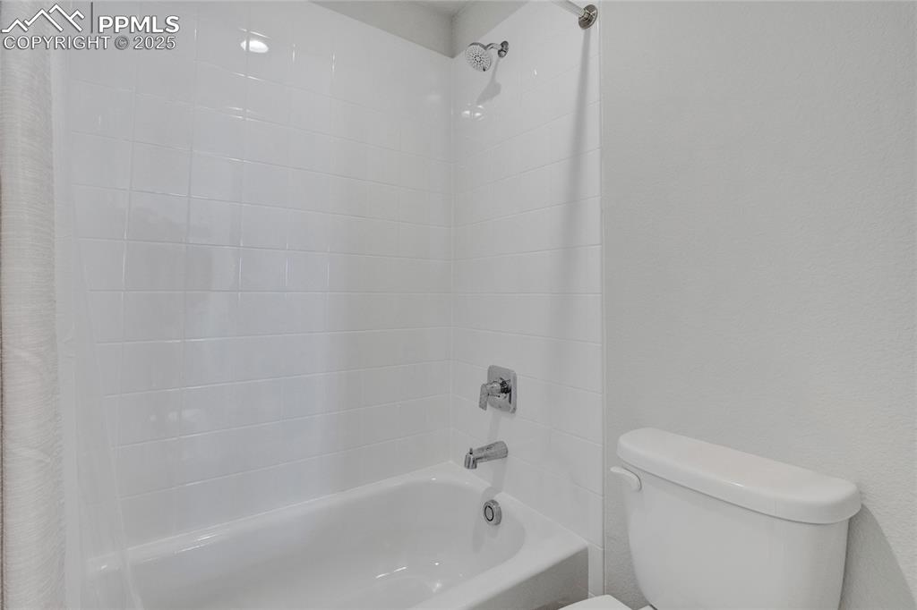 Image 33 of 41: Full bath featuring toilet and shower / tub combo