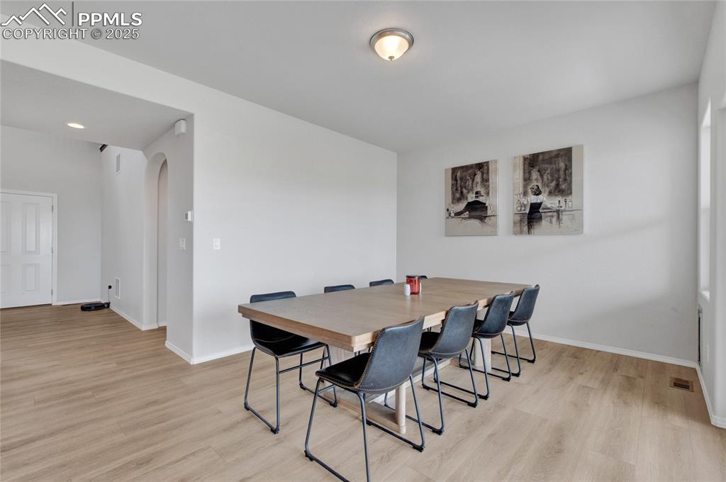 Image 7 of 41: Dining space with baseboards and light wood-style flooring