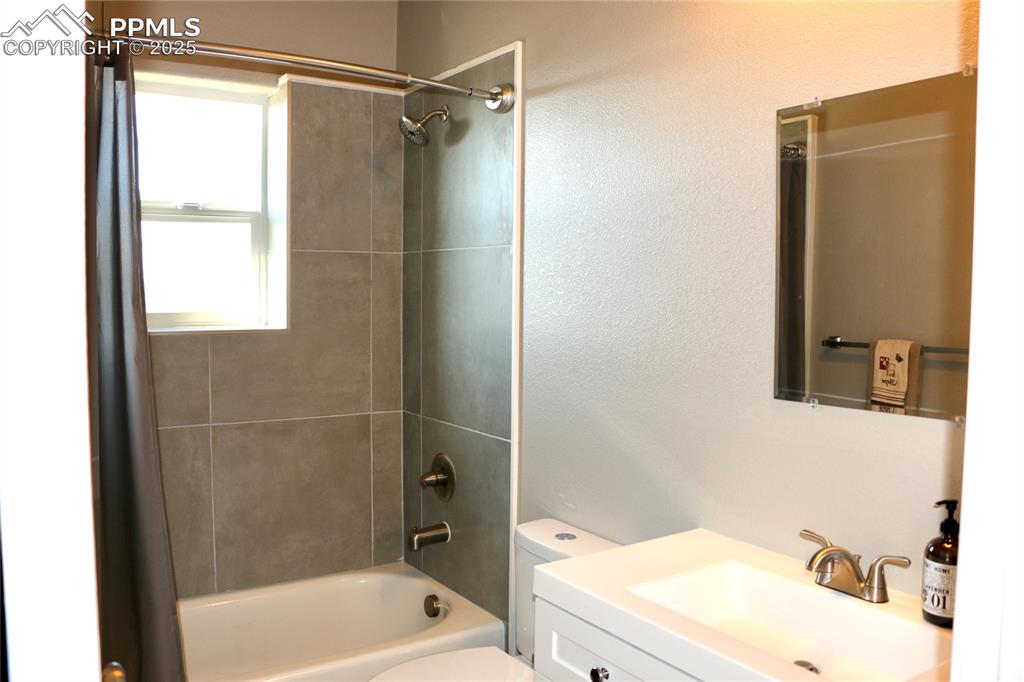 Image 15 of 28: Full bathroom featuring shower / tub combination and vanity