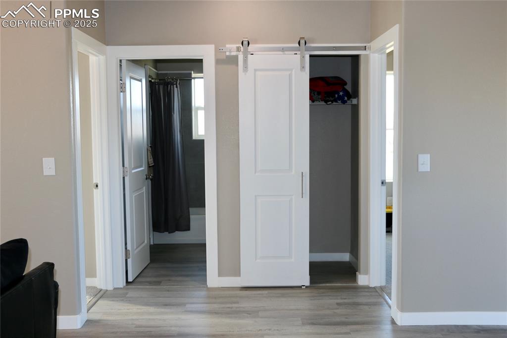 Image 21 of 28: View of closet and bathroom located off the living area between two bedroom