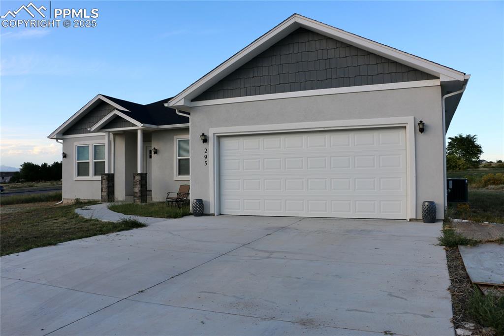 Image 24 of 28: Single story home featuring stucco siding, concrete driveway, and an attach