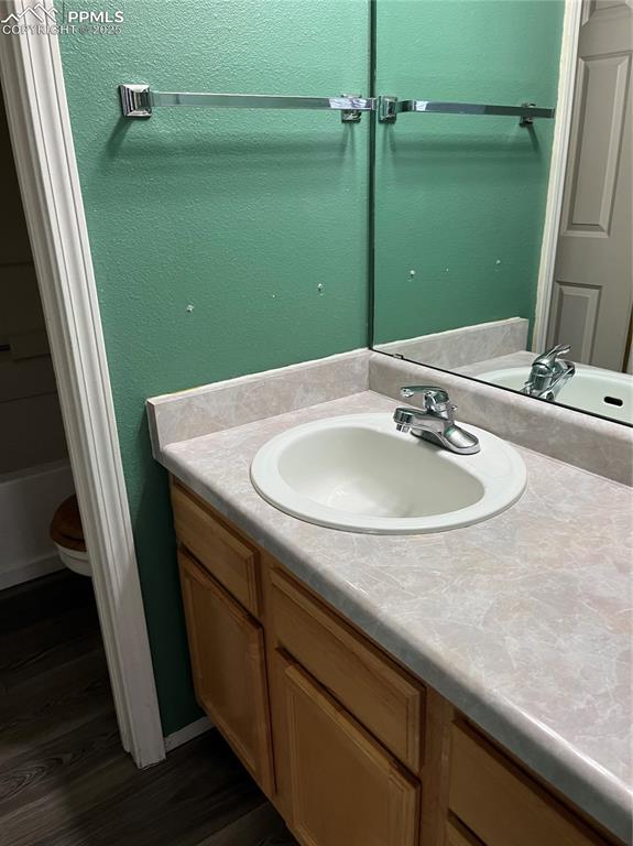 Image 7 of 7: Adjacent to main bedroom has vanity outside toilet and tub shower closet!!!