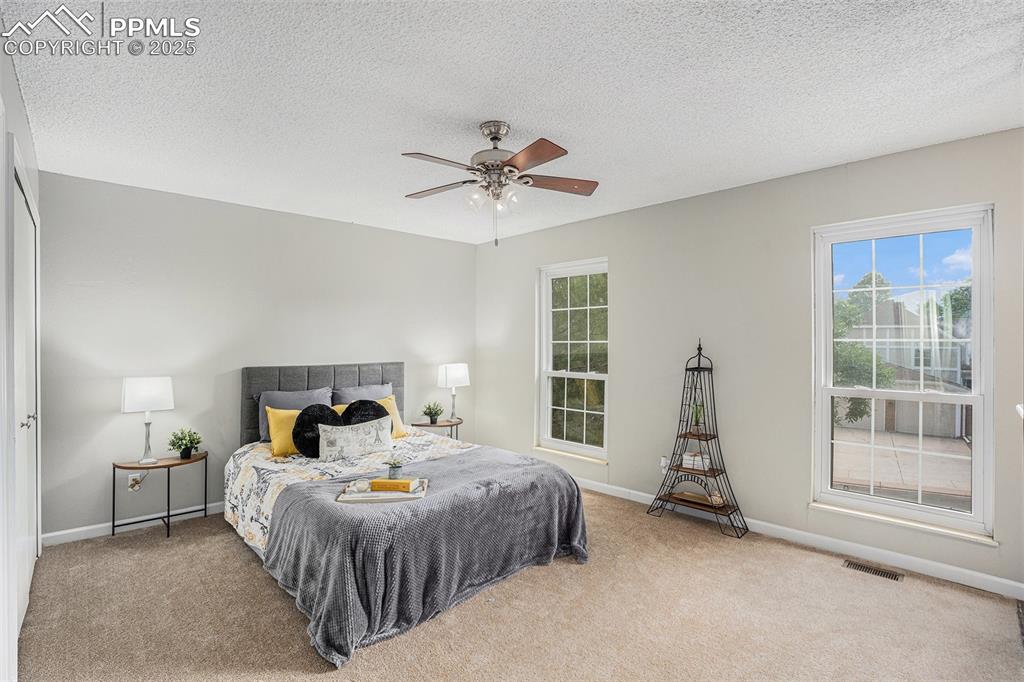 Image 17 of 34: Master bedroom with ceiling fan