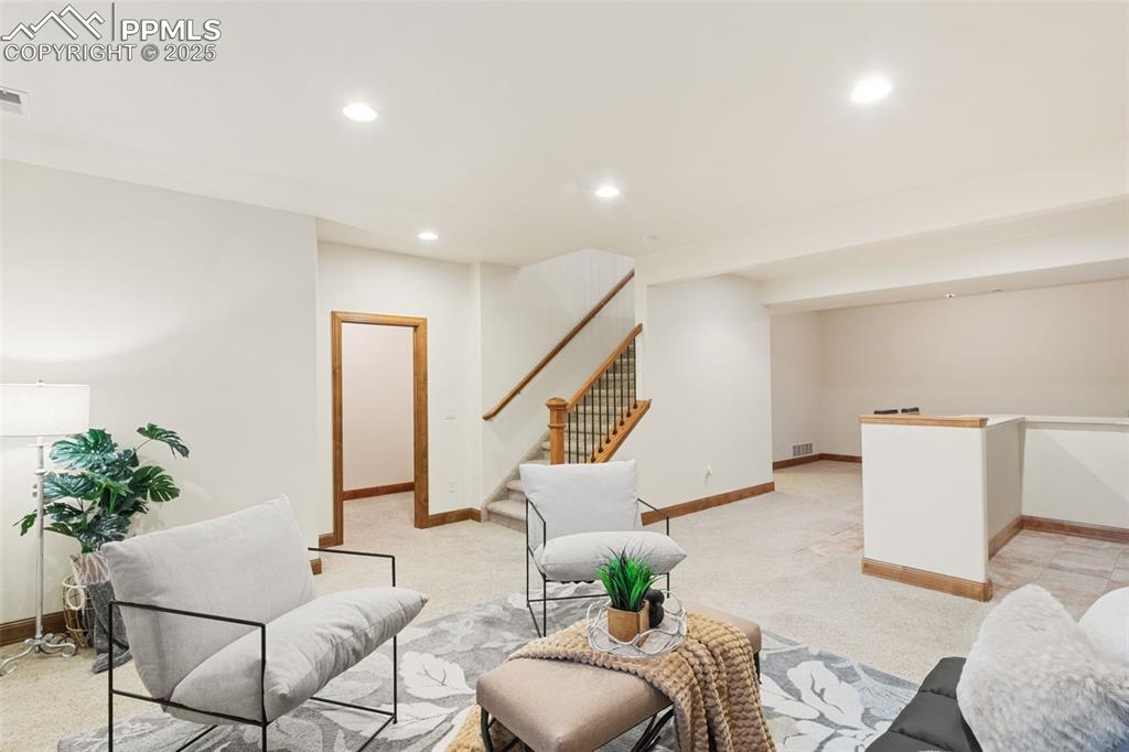 Image 31 of 47: Basement family room area with walk in storage closet.