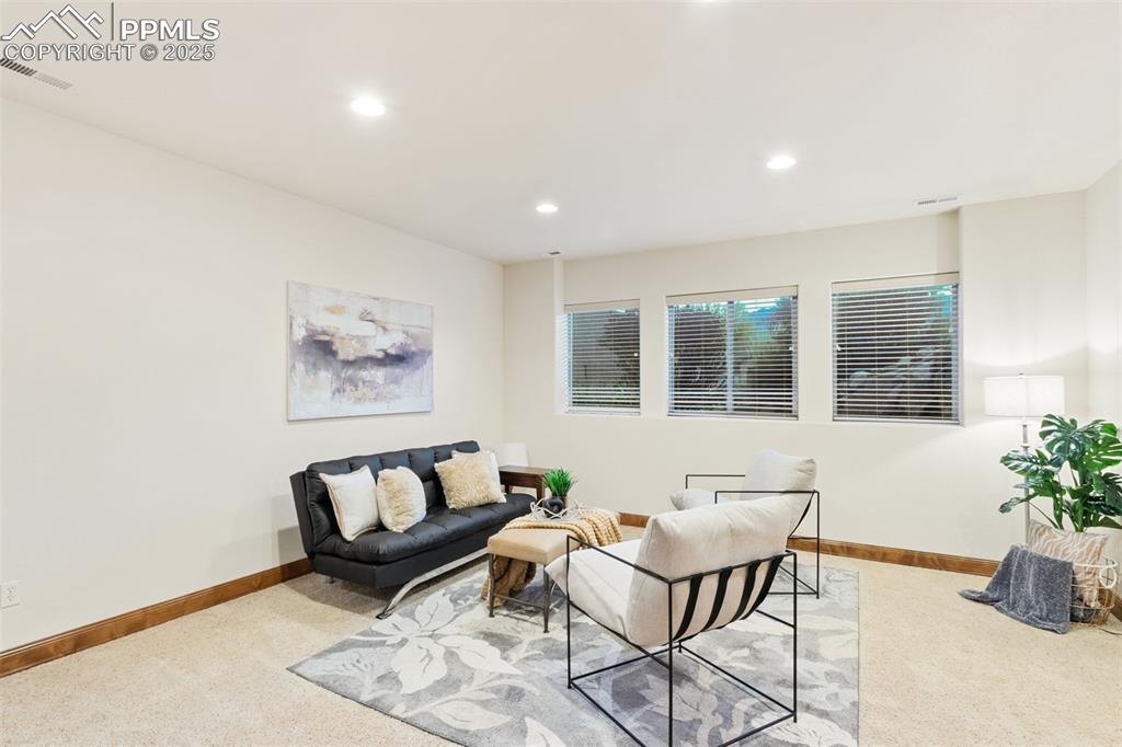Image 32 of 47: Basement family room with garden level windows that captures views of mount