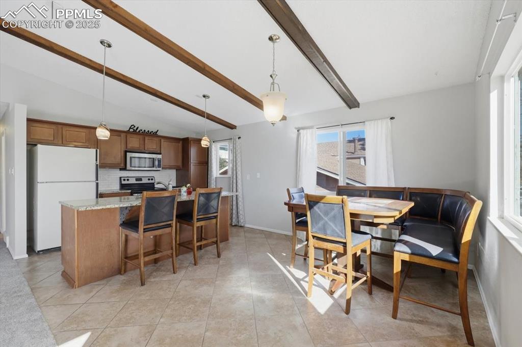 Image 23 of 47: Dining area and kitchen.