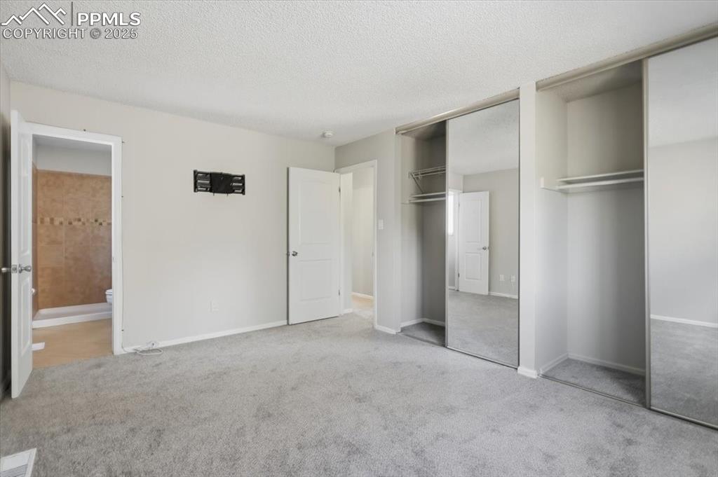 Image 28 of 47: Primary bedroom with attached bathroom.