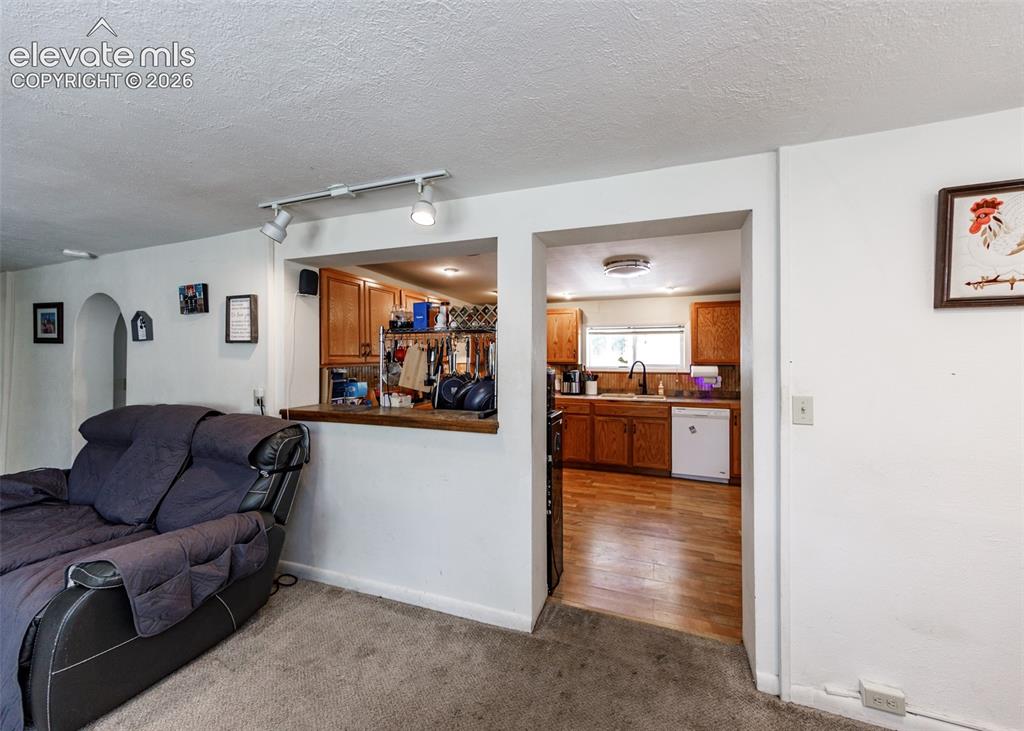 Image 9 of 39: view from living room into kitchen