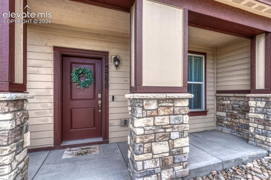 Image 10 of 40: Enjoy peaceful open space views from the covered front porch, the perfect s