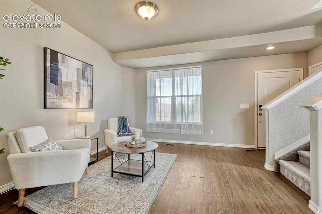 Image 12 of 40: Living Room with stairs to the upper level.