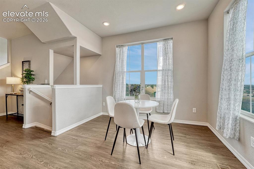 Image 15 of 40: The dining room showcases fabulous views & provides easy access to the kitc