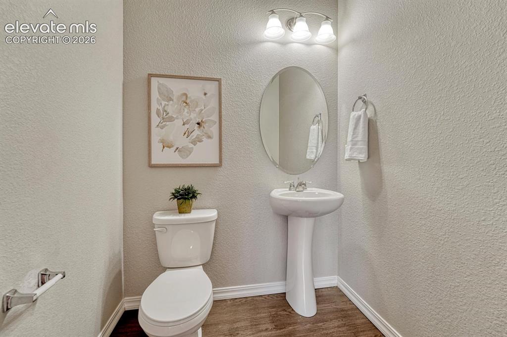 Image 20 of 40: Convenient Powder Bathroom with pedestal sink.