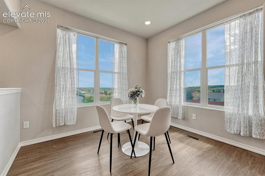 Image 3 of 40: The Dining Area features fabulous views and wood laminate flooring.