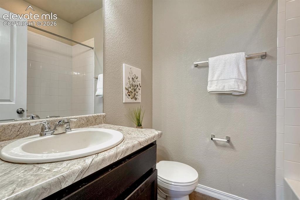 Image 30 of 40: Upper Level Full Bathroom with vanity, mirror, and tiled tub/shower.