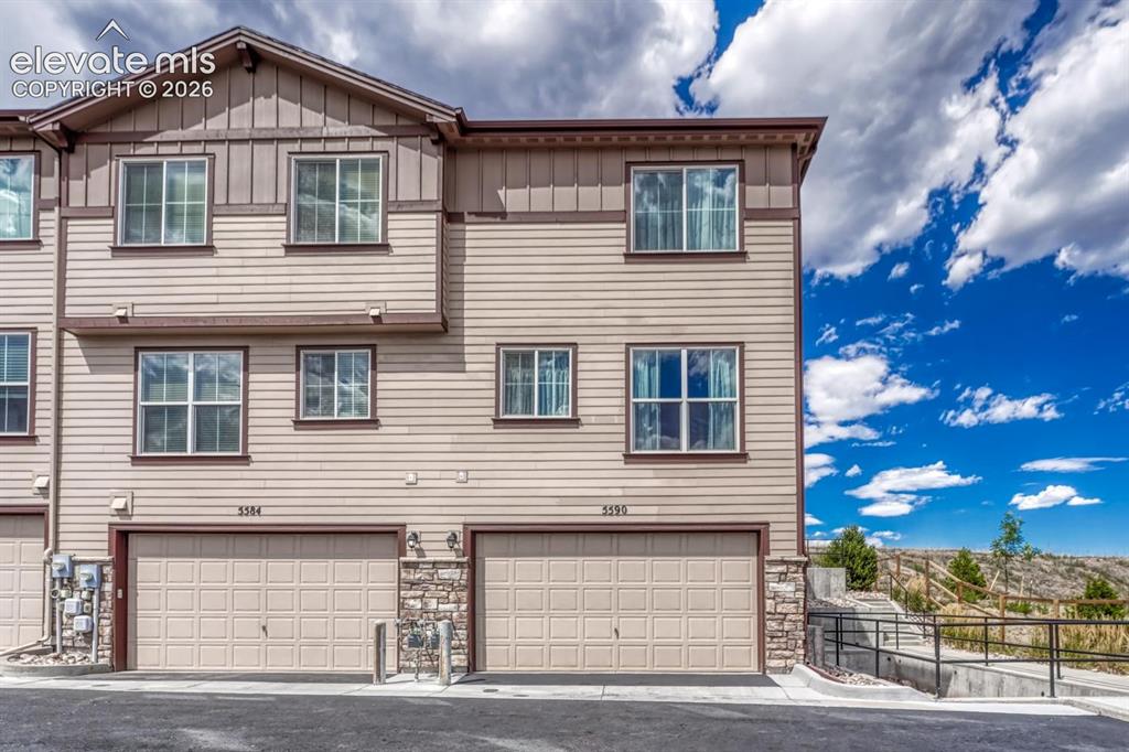 Image 33 of 40: Rear view of townhome with 2-car attached tandem garage.