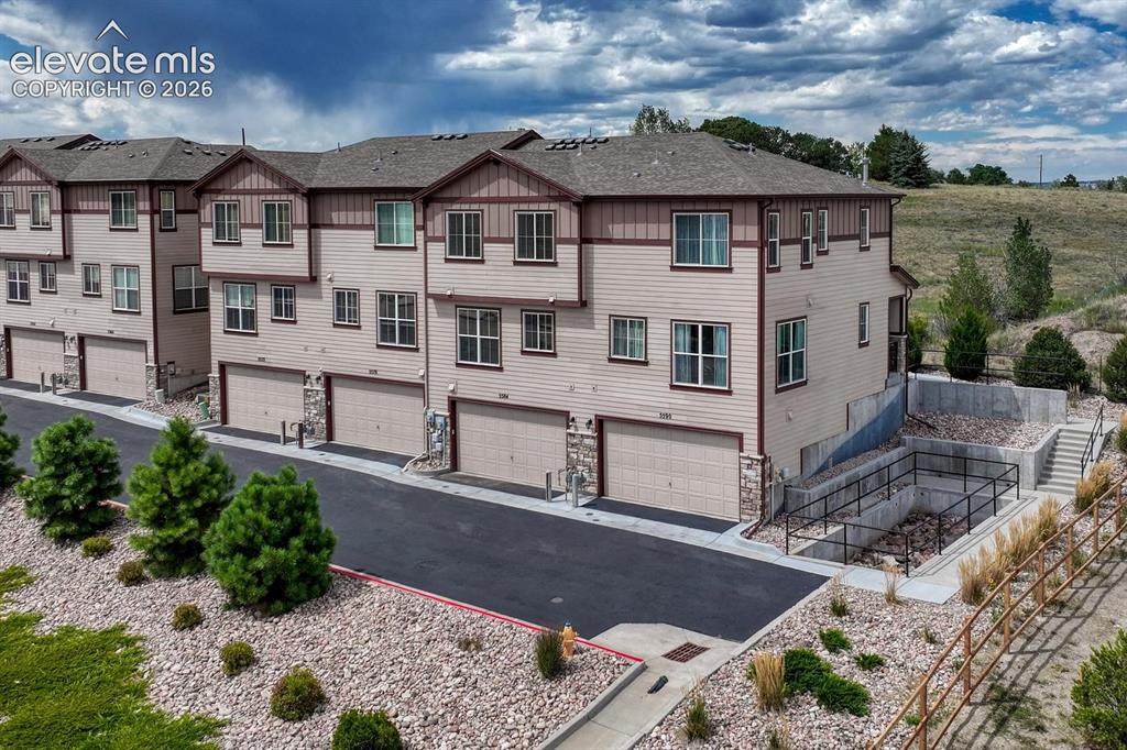 Image 36 of 40: Aerial rear view of building and attached garages.