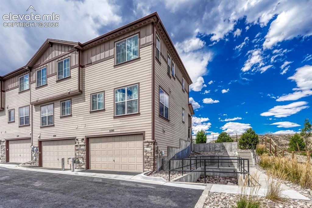 Image 8 of 40: This end unit townhome provides an oversized 2-car tandem garage with a SMA