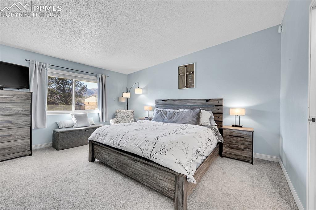 Image 11 of 30: 14x15 primary bedroom with new carpet. 