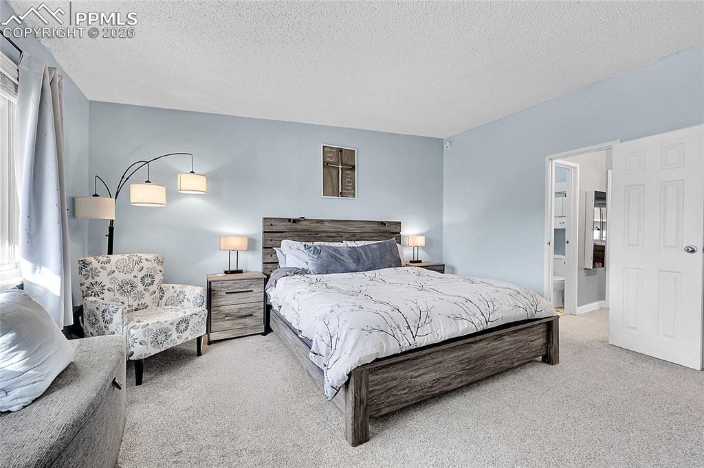 Image 12 of 30: Another view of primary bedroom. 