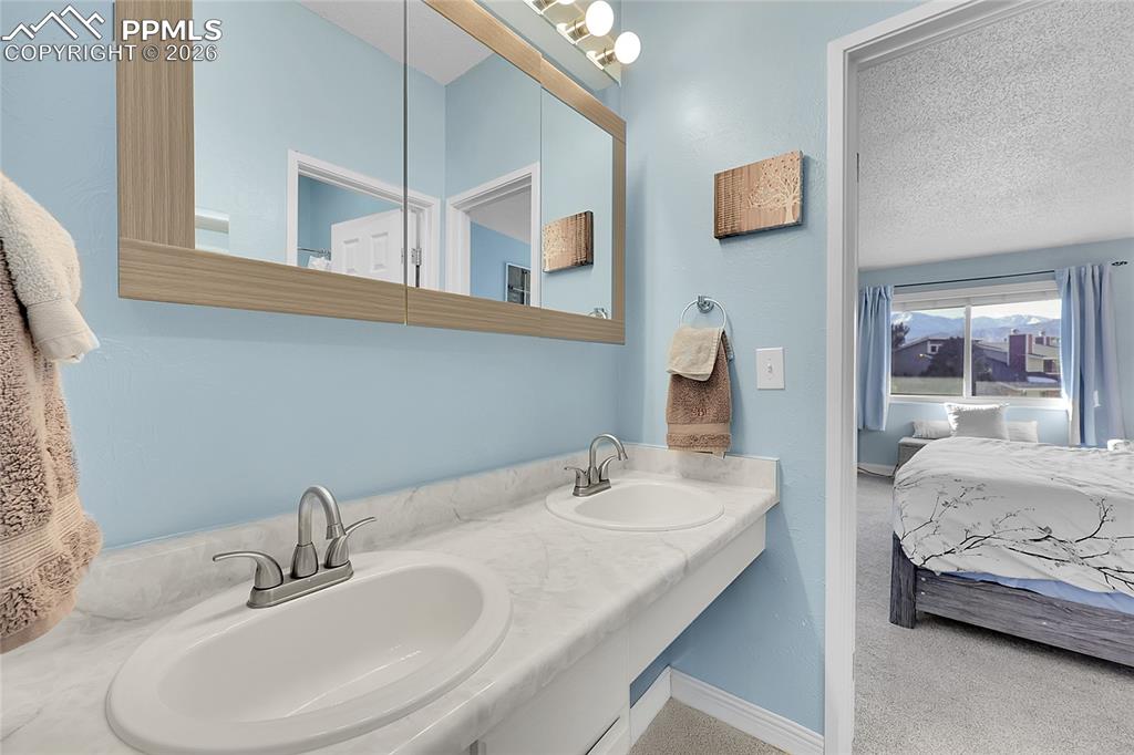 Image 13 of 30: Jack & Jill bathroom shared by both upstairs bedrooms. 