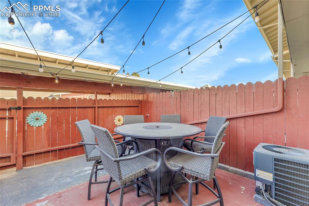 Image 20 of 30: Fully fenced private patio-gate leads to covered parking.