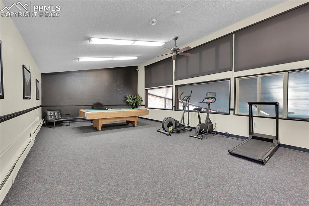 Image 29 of 30: Exercise room w/workout equipment.