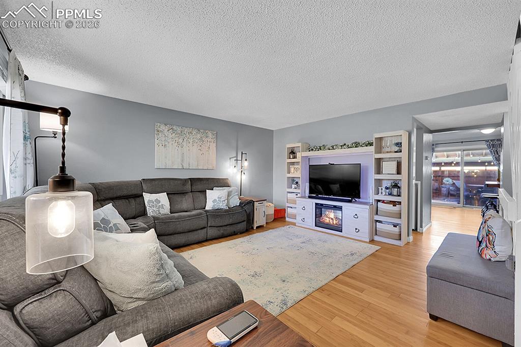Image 3 of 30: Oversized living room with hardwood floors.
