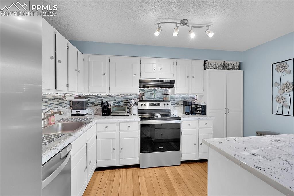 Image 5 of 30: Updated kitchen to include newer kitchen appliances.