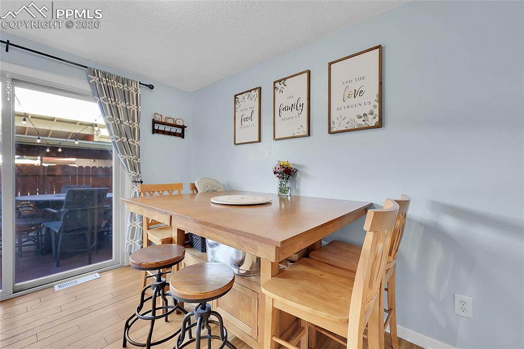 Image 7 of 30: Dining area with walkout to the fenced patio--great for entertaining.