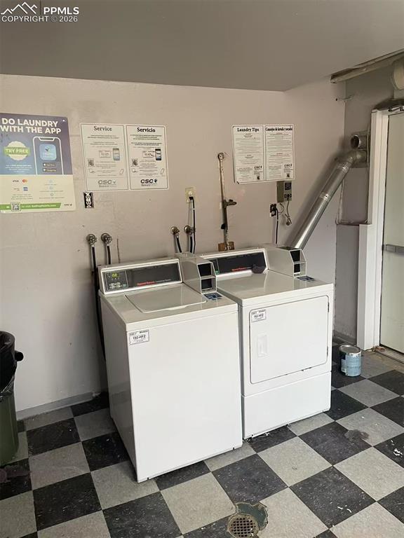 Image 29 of 29: Shared laundry room featuring washing machine and dryer