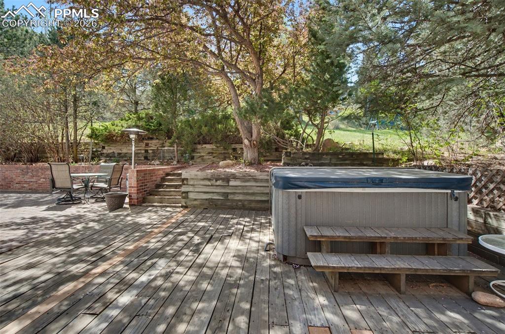 Image 24 of 27: Back deck and hot tub