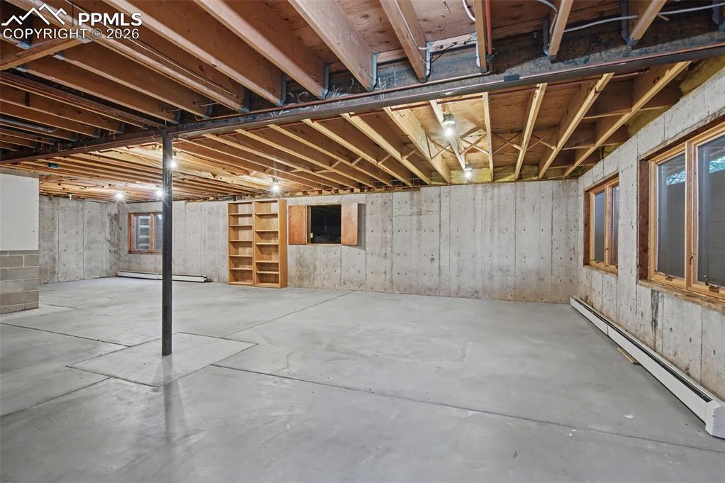Image 25 of 27: Unfinished basement is your blank canvas with egress!