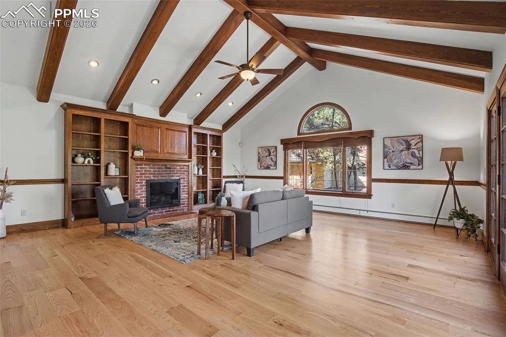 Image 8 of 27: Soaring ceilings, fireplace, built-in and deck access