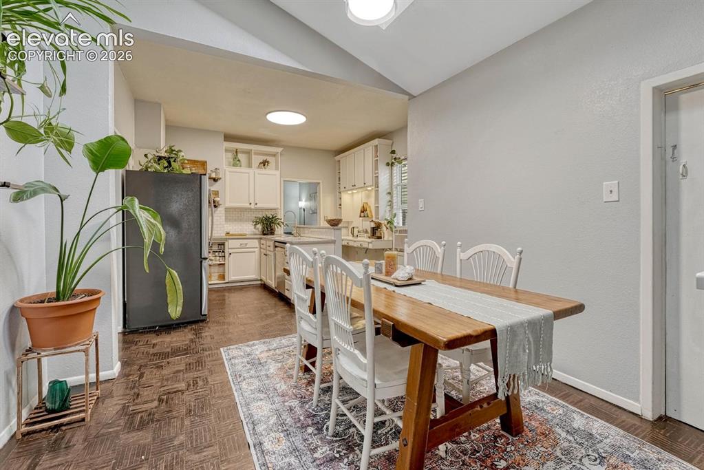 Image 16 of 50: Parquet wood flooring in the kitchen and dining room