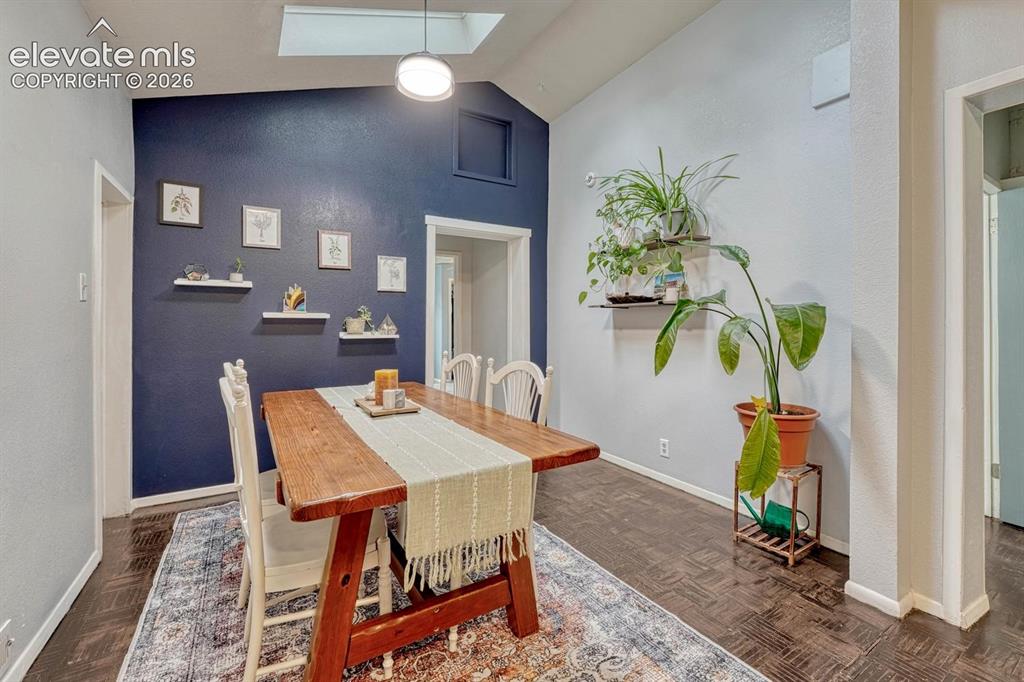 Image 17 of 50: Dining room features vaulted ceiling and operable skylights