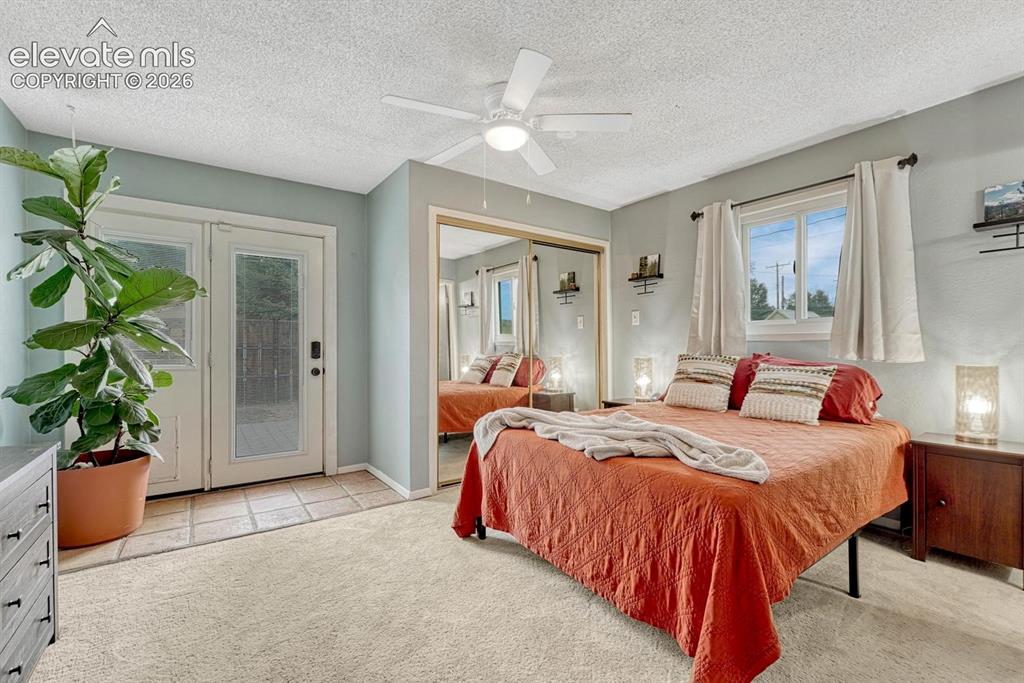 Image 19 of 50: Primary bedroom has attached bathroom and walk-out to back deck