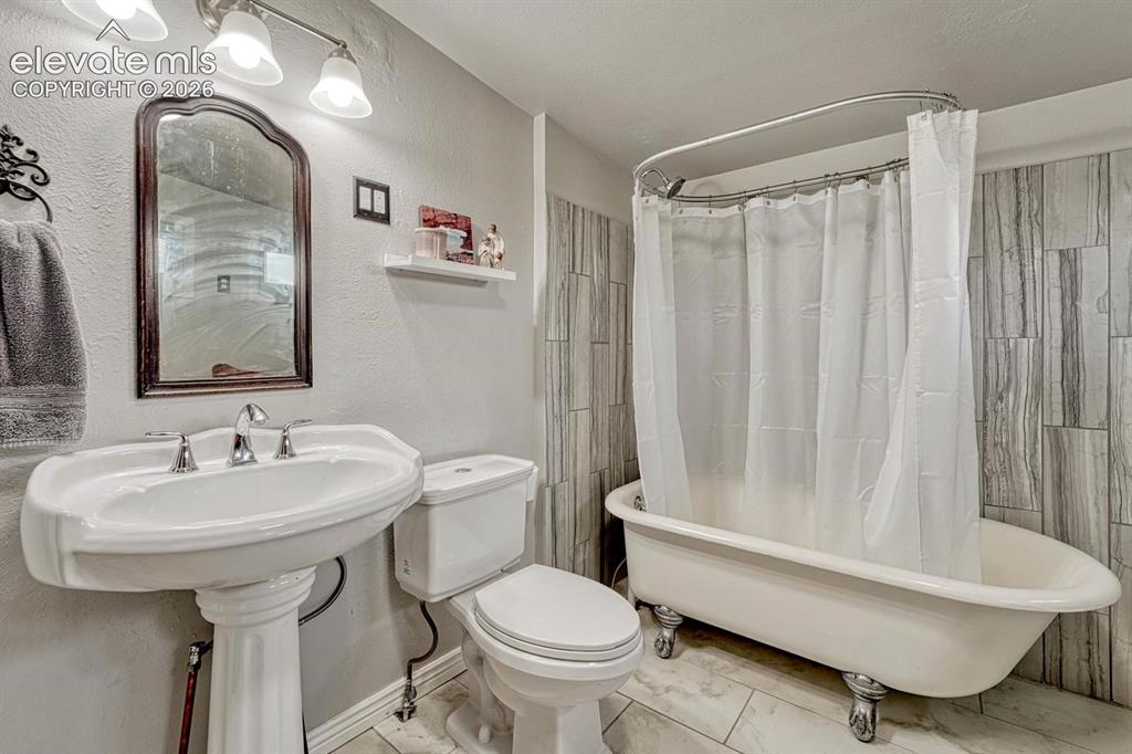 Image 29 of 50: Full bathroom features a classic clawfoot tub!
