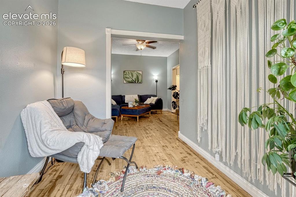 Image 34 of 50: Cozy sitting room with natural wood flooring