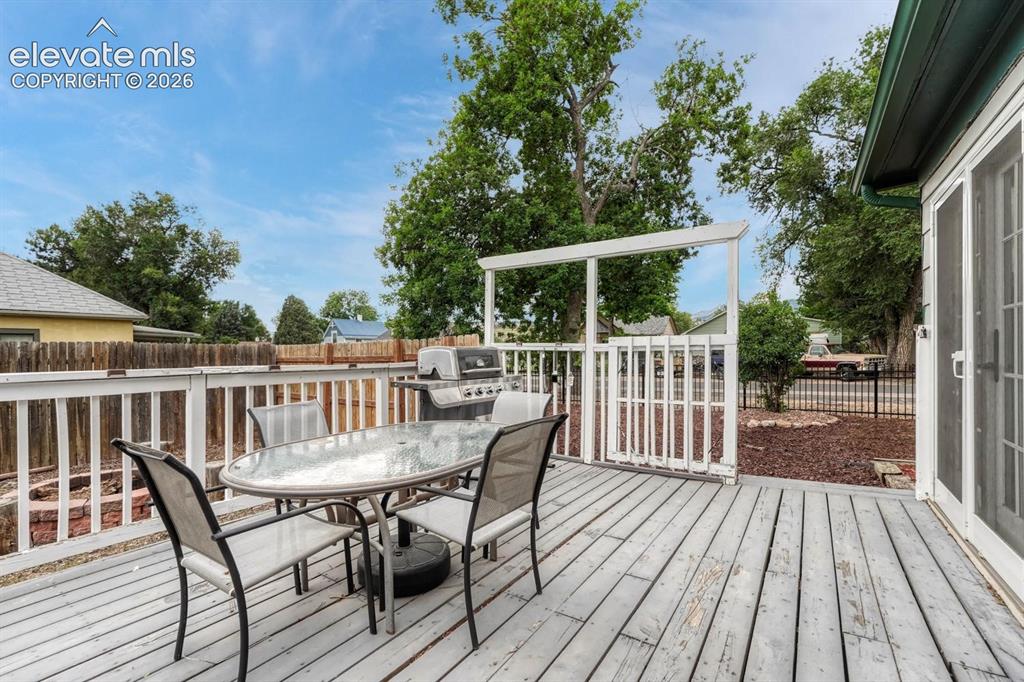Image 36 of 50: Large wood deck off the side of the house