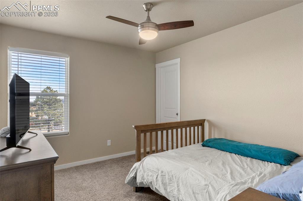 Image 15 of 32: Bedroom featuring light carpet and a ceiling fan