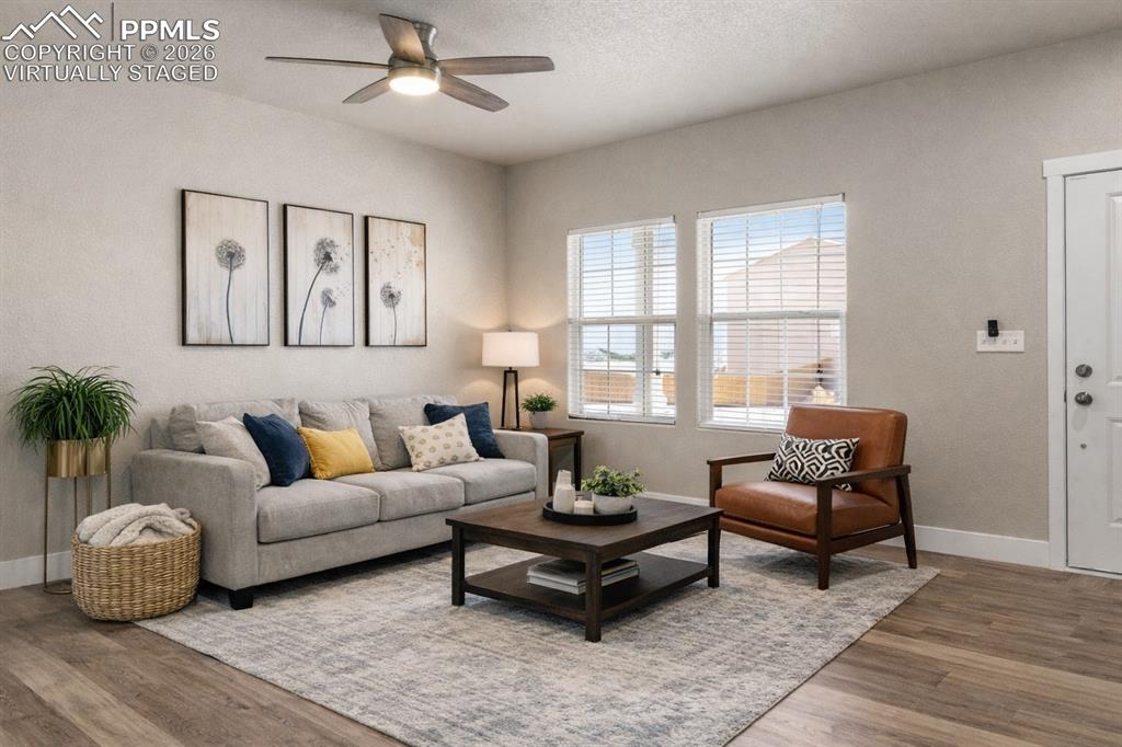 Image 2 of 32: Living room with ceiling fan and wood finished floors Virtually Staged