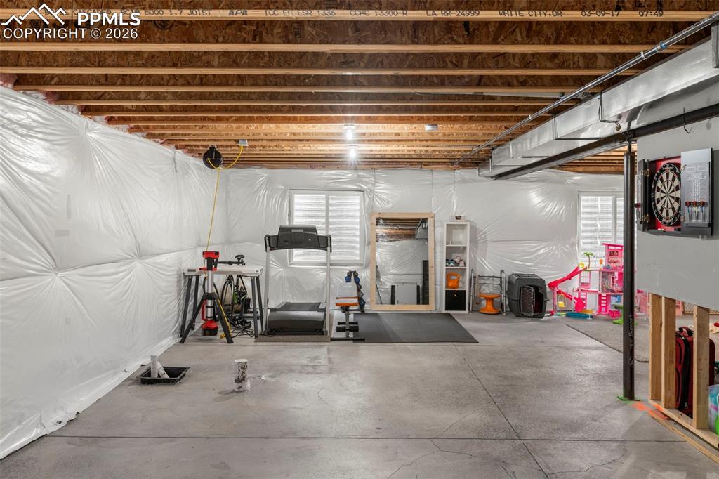 Image 25 of 32: Exercise room with concrete floors