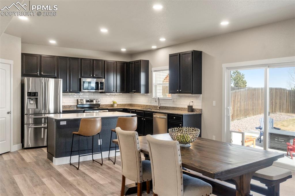 Image 4 of 32: Kitchen featuring stainless steel appliances, light wood-style flooring, a 