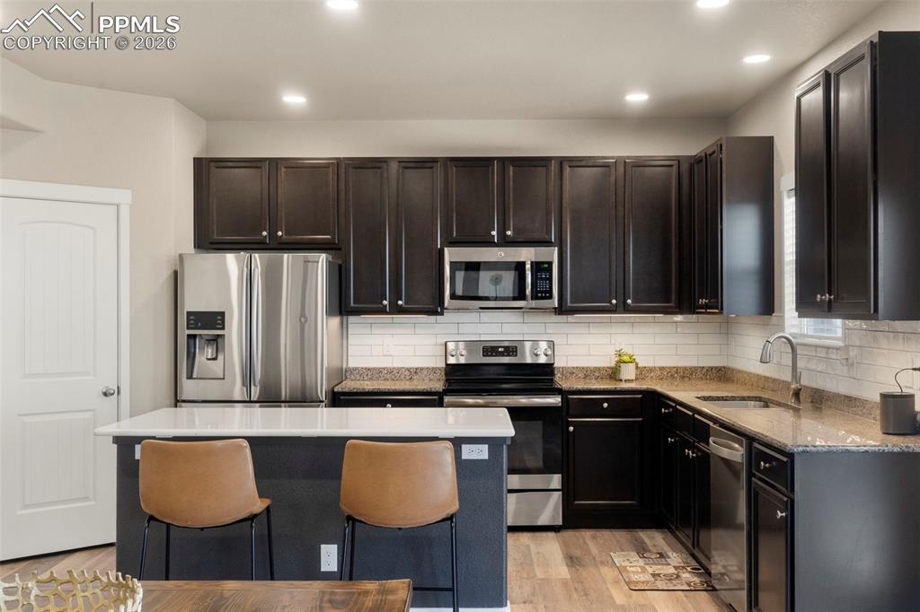 Image 5 of 32: Kitchen featuring stainless steel appliances, light wood-style flooring, a 