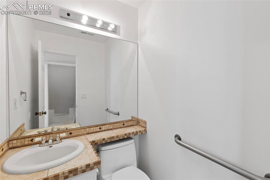Image 15 of 27: Bathroom with toilet and vanity