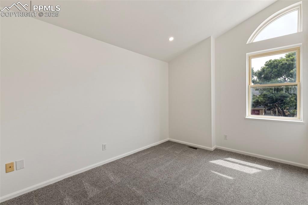 Image 17 of 27: Spare room featuring carpet floors, lofted ceiling, and recessed lighting